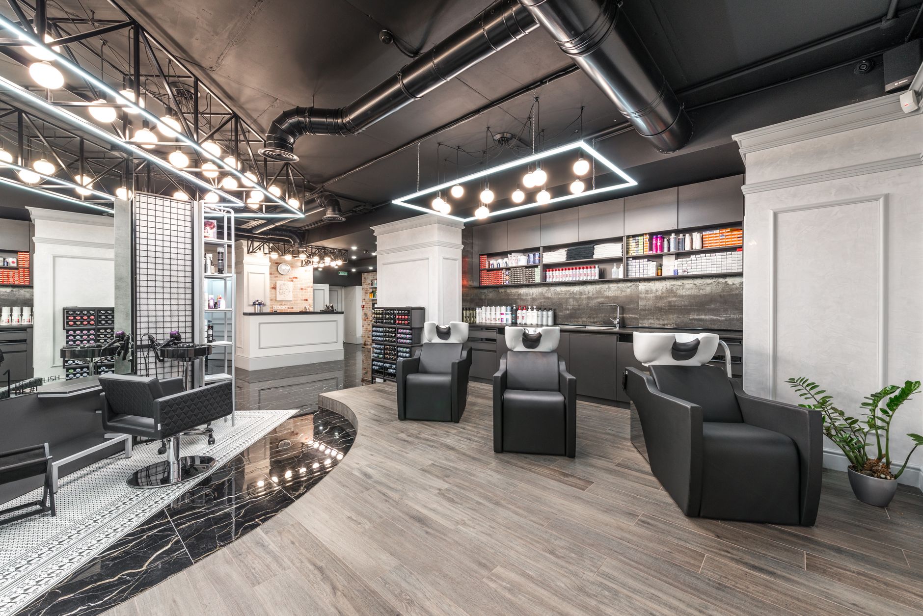 Stylist working on a client's hair in a modern salon with warm natural light